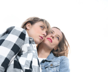 young casual homosexual couple looking away isolated on white