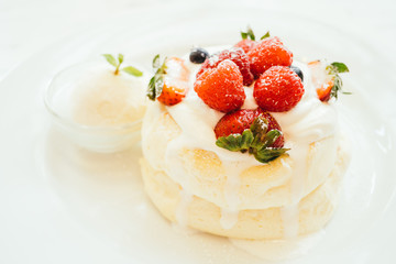 Pancake with ice cream strawberry , blueberry and raspberry