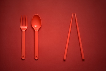Red Fork/Spoon & chopsticks on red background