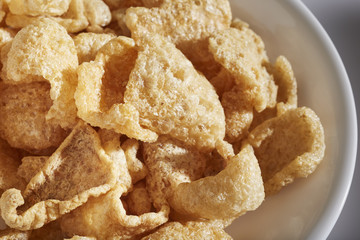 a bowl of fried pork skins