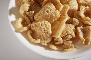 a bowl of fried pork skins