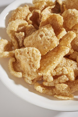 a bowl of fried pork skins