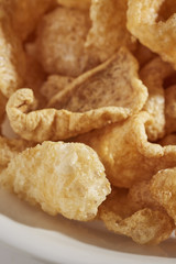 a bowl of fried pork skins