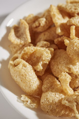 a bowl of fried pork skins