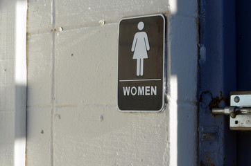 Women's restroom sign on empty building 