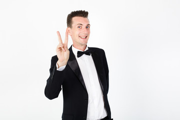 Young man master performing on the stage. Man in black suit on white background with copy space