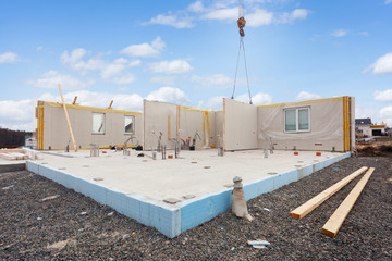 Building the energy efficient house. Structural insulated panels with plastic tubes in foundation