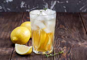 Glass of ice tea with lemon on wooden table Copy space Drink for hot summer day 