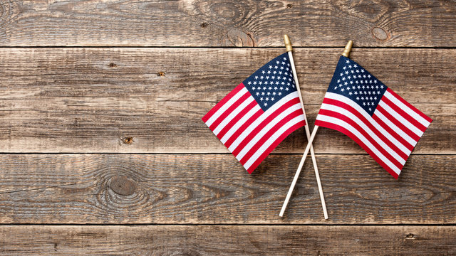 USA flags on wooden background