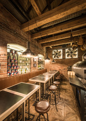 Wooden interior of restaurant with empty tables and bar stools