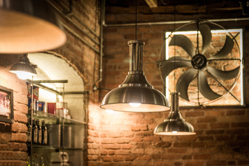 Fototapeta na wymiar Ceiling lamp an fan in interior of restaurant