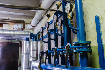 Heat-regulating equipment in the basement of a heated building / Photo taken in Russia. Heating...