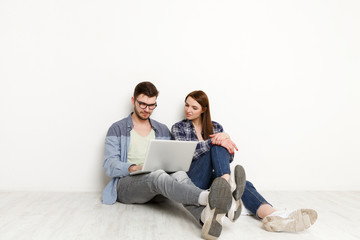 Couple choosing furniture online for new home