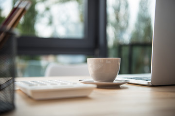 Modern office workplace with coffee and laptop computers