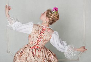 Beautiful woman in historic medieval dress. Back pose