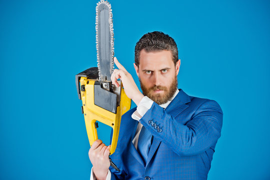 business man with chainsaw, fashion, serious businessman