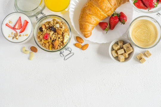 set of healthy ingredients for breakfast on white background. Top view with copy space