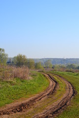 Fototapeta na wymiar Russian rural landscape with empty dirt road