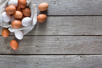 Fresh chicken brown eggs on linen, organic farming background