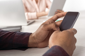 Cropped shot of person using smartphone with blank screen