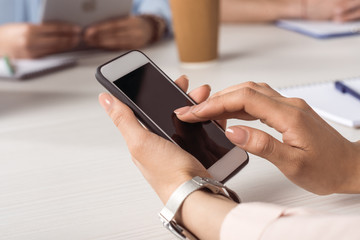 cropped shot of woman using smartphone with blank screen