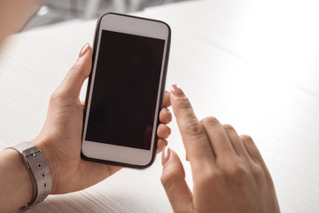 cropped shot of woman holding smartphone with blank screen