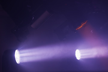 Purple spot lights with strong beams in smoke