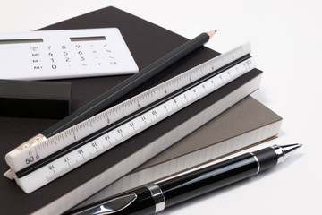 Modern business office desk table with modern business supplies book, pen ruler and calculator. Business office desk workplace with copy space.