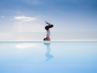 Asian woman practice yoga on the beach