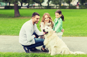 happy family with labrador retriever dog in park