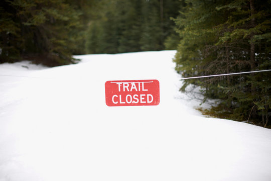 Warning sign on snow covered landscape, Banff, Canada