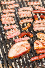 Frying pork and chicken meat on the barbecue grill