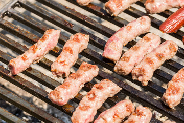 Frying pork and chicken meat on the barbecue grill
