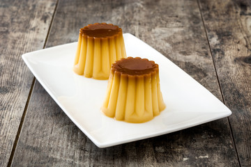Creme caramel. Egg pudding on wooden table.

