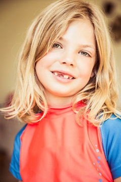 Portrait of young girl with missing milk teeth, smiling