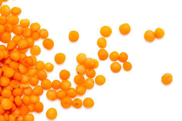 Red lentils on a white background