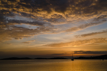 Beautiful Clouds at Sunset with A Sailboat