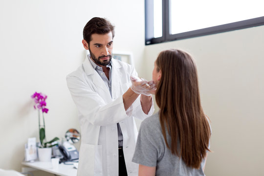 Cosmetic surgeon marking patient's face for surgery