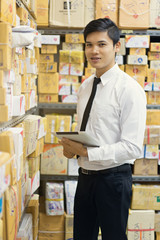 Worker checking package in warehouse.