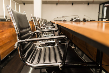Side view of Conference table and chairs in meeting room