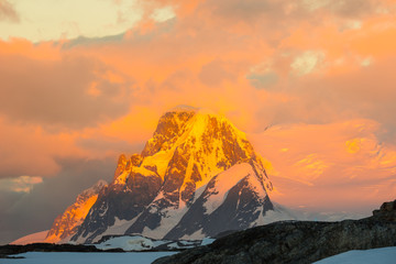 Glowing red mountains at sunset in Antarctica