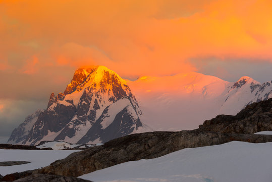 Glowing red mountains at sunset in Antarctica
