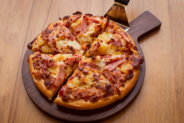 Hawaiian Pizza on wooden table.