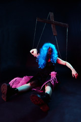 model in form of puppet doll with ropes and straps