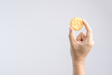Hand holding round biscuit