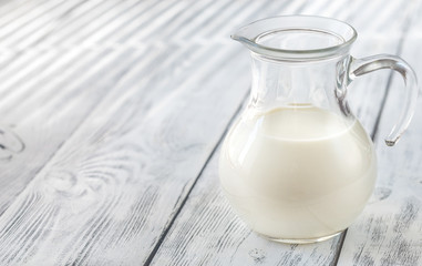 Glass pitcher of milk