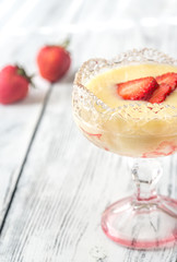 Sabayon with strawberry slices on the wooden background