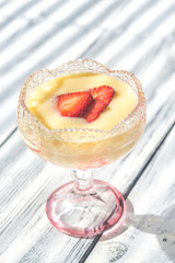 Sabayon with strawberry slices on the wooden background