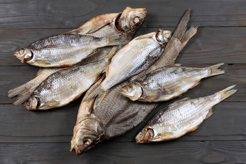 Dried fish on the table. Salty dry river fish on a dark wooden background.top view with copy space