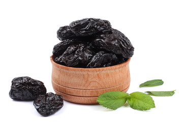 Dried plums - prunes in wooden bowl isolated on white background